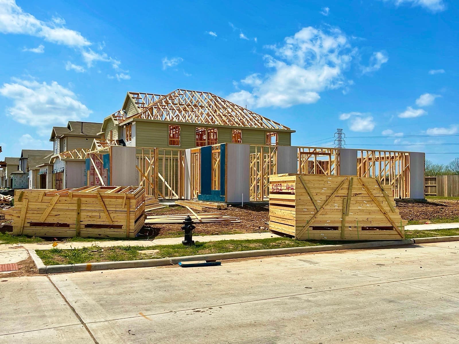 New home construction on sunny day in suburbs.