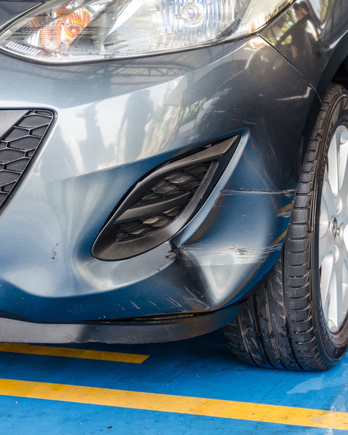 Damaged car bumper requiring repair.